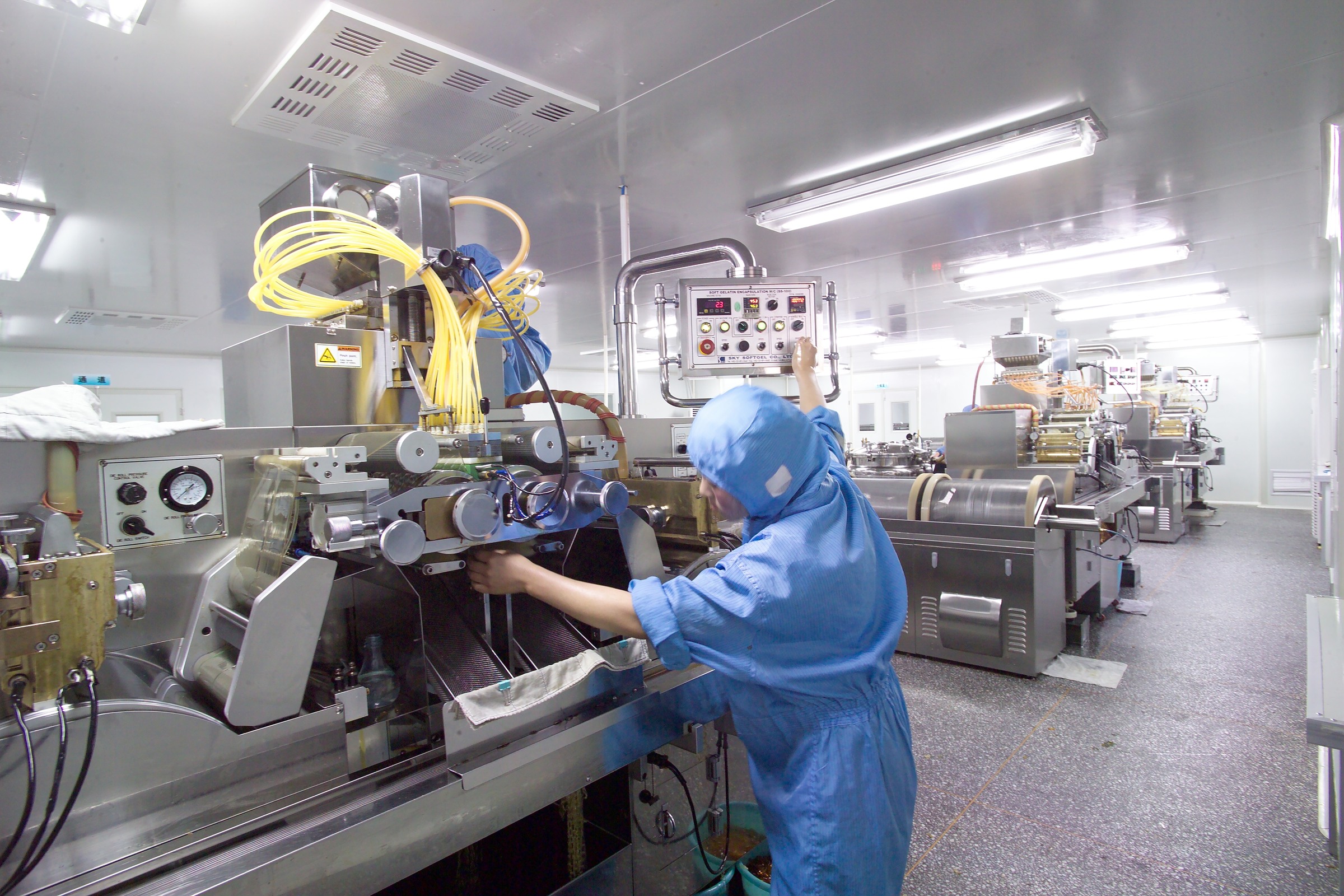 Softgel production equipment and operator in a clean manufacturing environment